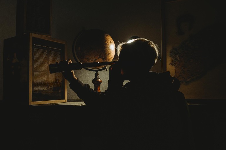 Boy looking through telescope at Maritime Museum in Reykjavik 