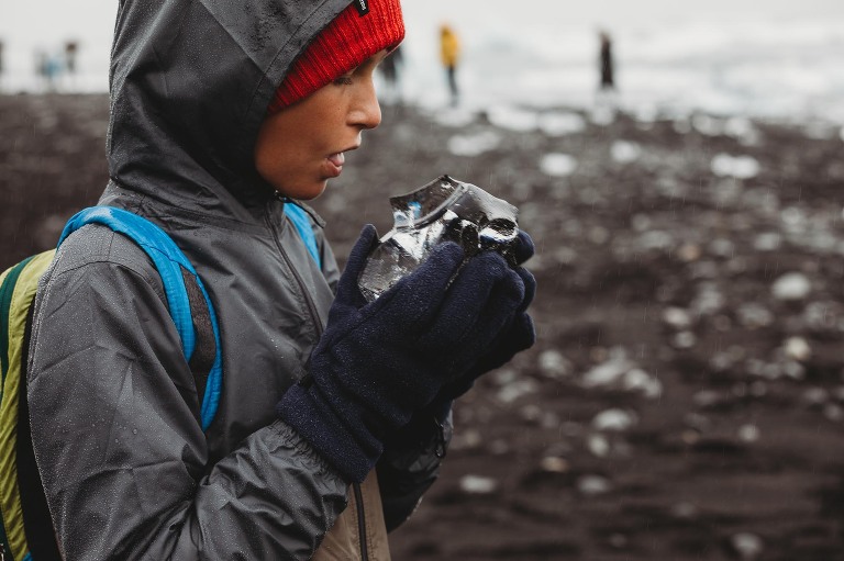 boy licking glacier at diamond beach, Iceland
