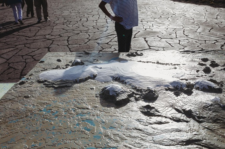 Thingvellir national park Iceland boy in t shirt looking at map