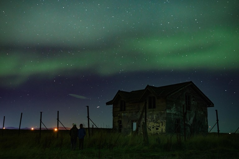 Aurora Borealis northern lights near old barn Reykjanes peninsula