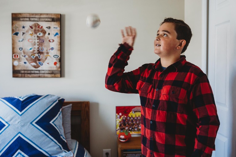 boy tossing a baseball