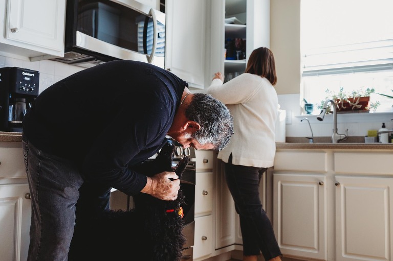family in kitchen with puppy