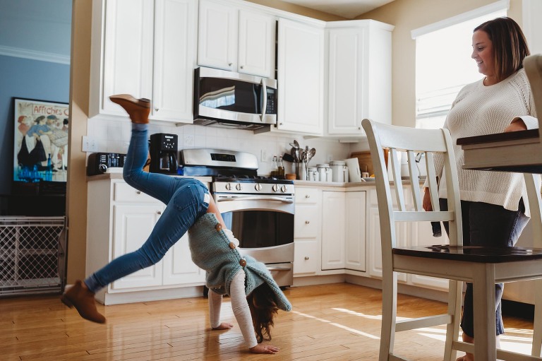 girl doing gymnastics in kitchen