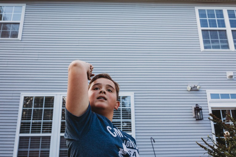 boy playing football with family