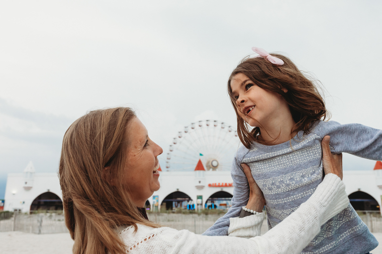 Mother and daughter on the beach in front of Gillian's Wonderland Pier