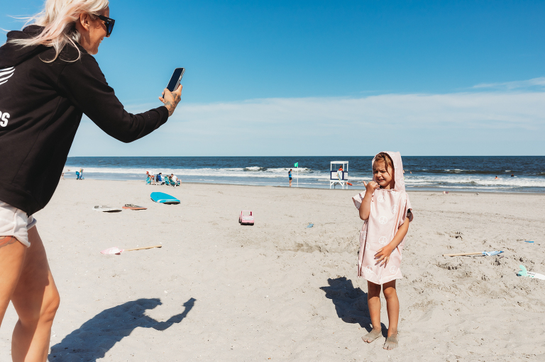 little girl surfer in changing towel