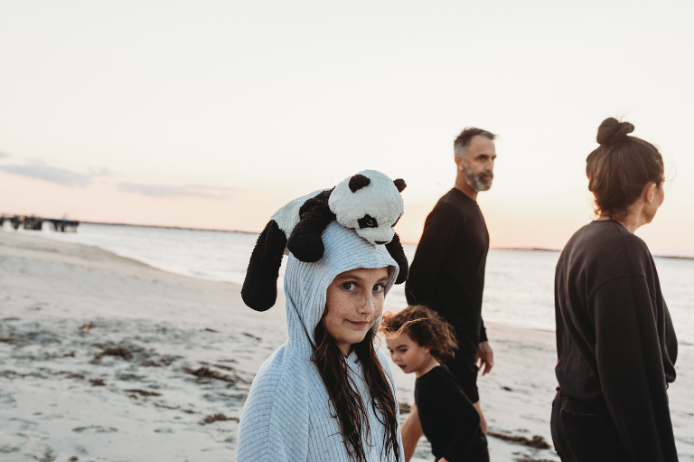 girl and her special panda bear while on walk with her family