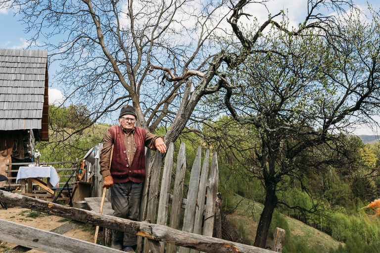 environmental portrait of Transylvanian man at his homestead